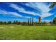 Expansive green lawn and landscaping offer a beautiful view of the community clock tower at 776 Tillis Pl, Las Vegas, NV 89138