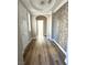 Inviting hallway boasts stylish tiled accent wall and hardwood floors at 776 Tillis Pl, Las Vegas, NV 89138