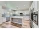 Stylish kitchen featuring white cabinets, an island, and stainless steel appliances at 776 Tillis Pl, Las Vegas, NV 89138