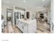 Open-concept kitchen with a large island, stainless steel appliances, and hardwood floors at 776 Tillis Pl, Las Vegas, NV 89138