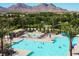 Aerial view of the community pool surrounded by landscaping and mountains at 776 Tillis Pl, Las Vegas, NV 89138