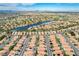 Breathtaking aerial showcases a community with lush green spaces and waterfront properties along the lake at 8416 Dry Cliff Cir, Las Vegas, NV 89128