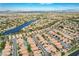 An aerial captures a large community surrounding a lake with beautiful houses and desert landscaping at 8416 Dry Cliff Cir, Las Vegas, NV 89128
