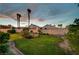 Exterior view of the home, highlighting its well-maintained backyard with a lush lawn and patio at 8416 Dry Cliff Cir, Las Vegas, NV 89128