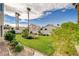 Serene backyard featuring manicured lawn, mature landscaping, and a peaceful ambiance at 8416 Dry Cliff Cir, Las Vegas, NV 89128
