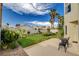 Large backyard featuring lush lawn, garden beds, and patio area with outdoor seating at 8416 Dry Cliff Cir, Las Vegas, NV 89128