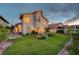Manicured backyard with lush green lawn and desert landscaping as the sun sets at 8416 Dry Cliff Cir, Las Vegas, NV 89128
