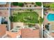 A beautiful backyard features a green lawn, patio seating, lush landscaping, and an inviting pool with lounge chairs at 8416 Dry Cliff Cir, Las Vegas, NV 89128