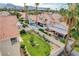 A backyard oasis with a well-manicured lawn, mature trees, garden beds, and a sparkling pool with lounge area at 8416 Dry Cliff Cir, Las Vegas, NV 89128