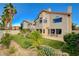 Spacious backyard showcasing manicured lawn, patio seating, and mature trees for privacy at 8416 Dry Cliff Cir, Las Vegas, NV 89128
