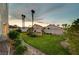 Beautifully landscaped backyard featuring a lush green lawn, mature trees, and a private garden area at 8416 Dry Cliff Cir, Las Vegas, NV 89128