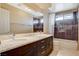 Modern bathroom with a double sink vanity, large mirror, and tiled shower/tub combination at 8416 Dry Cliff Cir, Las Vegas, NV 89128