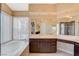 Bathroom features a luxurious soaking tub and vanity with a marble countertop and lots of storage at 8416 Dry Cliff Cir, Las Vegas, NV 89128