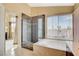 Bright bathroom showcases a glass shower, a soaking tub, and large windows at 8416 Dry Cliff Cir, Las Vegas, NV 89128