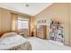 This bedroom features a window, a dresser, and a bookshelf filled with books at 8416 Dry Cliff Cir, Las Vegas, NV 89128