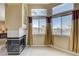 This bedroom features a fireplace, large windows, and neutral walls at 8416 Dry Cliff Cir, Las Vegas, NV 89128