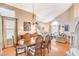 Bright dining area with hardwood floors, high ceilings, and adjacent seating area at 8416 Dry Cliff Cir, Las Vegas, NV 89128