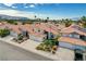 Beautiful view of a two-story home with a terracotta roof, landscaped yard, and spacious driveway in a friendly neighborhood at 8416 Dry Cliff Cir, Las Vegas, NV 89128