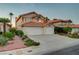Inviting two-story home with a spacious driveway, a two-car garage, and lush front yard landscaping at 8416 Dry Cliff Cir, Las Vegas, NV 89128