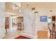 Spacious foyer with a curved staircase, display cabinet, and views into the living room and kitchen at 8416 Dry Cliff Cir, Las Vegas, NV 89128