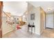 Bright foyer featuring tile flooring, staircase, and entry to the living room with large windows at 8416 Dry Cliff Cir, Las Vegas, NV 89128