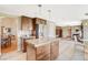 Bright kitchen features a granite island, stainless steel appliances, and wood cabinets at 8416 Dry Cliff Cir, Las Vegas, NV 89128