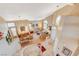 Bright living room with hardwood floors, comfortable seating, and staircase looking over the space at 8416 Dry Cliff Cir, Las Vegas, NV 89128