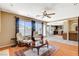 Sunlit living room featuring a fireplace, hardwood floors, and large windows at 8416 Dry Cliff Cir, Las Vegas, NV 89128