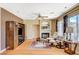 Bright living room features a fireplace, hardwood floors, and large windows at 8416 Dry Cliff Cir, Las Vegas, NV 89128