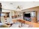 Spacious living room with fireplace, hardwood floors, and a built-in media center at 8416 Dry Cliff Cir, Las Vegas, NV 89128
