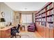 Study with built-in bookshelves, wood floors, and large window with natural light at 8416 Dry Cliff Cir, Las Vegas, NV 89128
