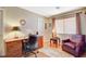 Well-lit office with plush chair, wood floors, and a large window at 8416 Dry Cliff Cir, Las Vegas, NV 89128