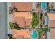 Aerial view showcasing a backyard with a lush green lawn, mature trees, and a sparkling pool at 8416 Dry Cliff Cir, Las Vegas, NV 89128