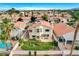 Two-story home shows a well-kept lawn, seating, mature trees, and is adjacent to a sparkling pool at 8416 Dry Cliff Cir, Las Vegas, NV 89128