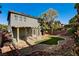A large backyard featuring desert landscaping, turf, covered patio, and a private fence at 9021 Rendon St, Las Vegas, NV 89143