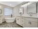 This bright bathroom features double sinks and a freestanding tub at 9021 Rendon St, Las Vegas, NV 89143
