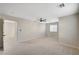 A clean bedroom with neutral carpet, a ceiling fan and a large window to let in natural light at 9021 Rendon St, Las Vegas, NV 89143