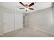 Bright bedroom featuring a ceiling fan, neutral walls, and a closet with large, sliding doors at 9021 Rendon St, Las Vegas, NV 89143
