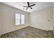 Well-lit bedroom featuring modern wood-look flooring, ample natural light, and a contemporary ceiling fan at 9021 Rendon St, Las Vegas, NV 89143
