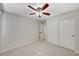 Bright bedroom featuring a ceiling fan, neutral walls, and a closet with large, sliding doors at 9021 Rendon St, Las Vegas, NV 89143