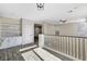 Open bonus room with light floors, railing, built in cabinets, and recessed lights at 9021 Rendon St, Las Vegas, NV 89143