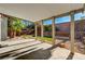 View from covered patio overlooking backyard with desert landscaping and brick retaining wall at 9021 Rendon St, Las Vegas, NV 89143