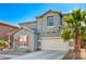 Well-maintained two-story home with attached garage, blue-gray facade, and a large palm tree at 9021 Rendon St, Las Vegas, NV 89143