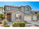 Inviting two-story home with a neutral facade, red tile roof, and a manicured front yard at 9021 Rendon St, Las Vegas, NV 89143