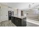 This open kitchen features a center island and stainless steel appliances, connecting seamlessly to the living area at 9021 Rendon St, Las Vegas, NV 89143