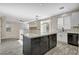Open-concept kitchen featuring a large island, stainless steel appliances, and bright, natural light at 9021 Rendon St, Las Vegas, NV 89143