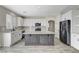 Spacious kitchen with white cabinetry, stainless appliances, tile backsplash, and a central island at 9021 Rendon St, Las Vegas, NV 89143