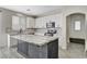 Modern kitchen with white cabinetry, stainless appliances, and a large central island with a marble countertop at 9021 Rendon St, Las Vegas, NV 89143