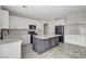 This kitchen features white cabinets, black hardware, stainless steel appliances, and a center island at 9021 Rendon St, Las Vegas, NV 89143