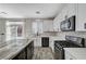 Beautiful kitchen with stainless steel appliances, a central island with bar seating, and bright lighting at 9021 Rendon St, Las Vegas, NV 89143